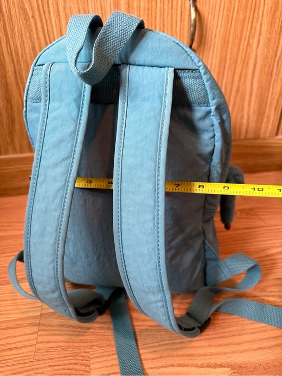 Kipling Challenger Medium Backpack in a teal color with a matching monkey charm.